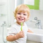 young boy brushing teeth