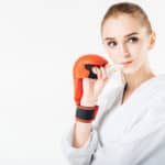 girl boxer holding sports mouthguard